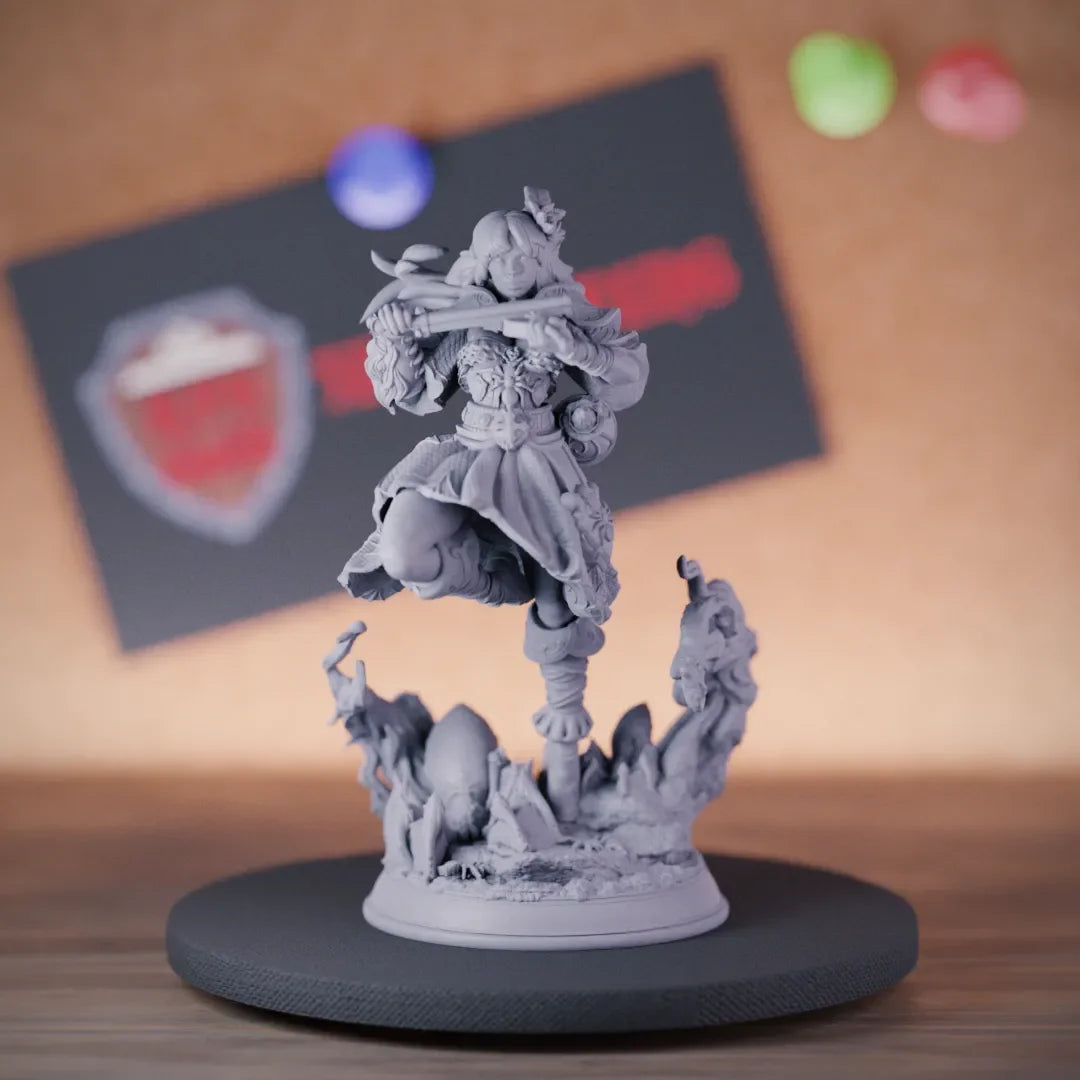 Drow bard miniature in layered robes, arms raised dramatically, standing on a base of jagged rocks